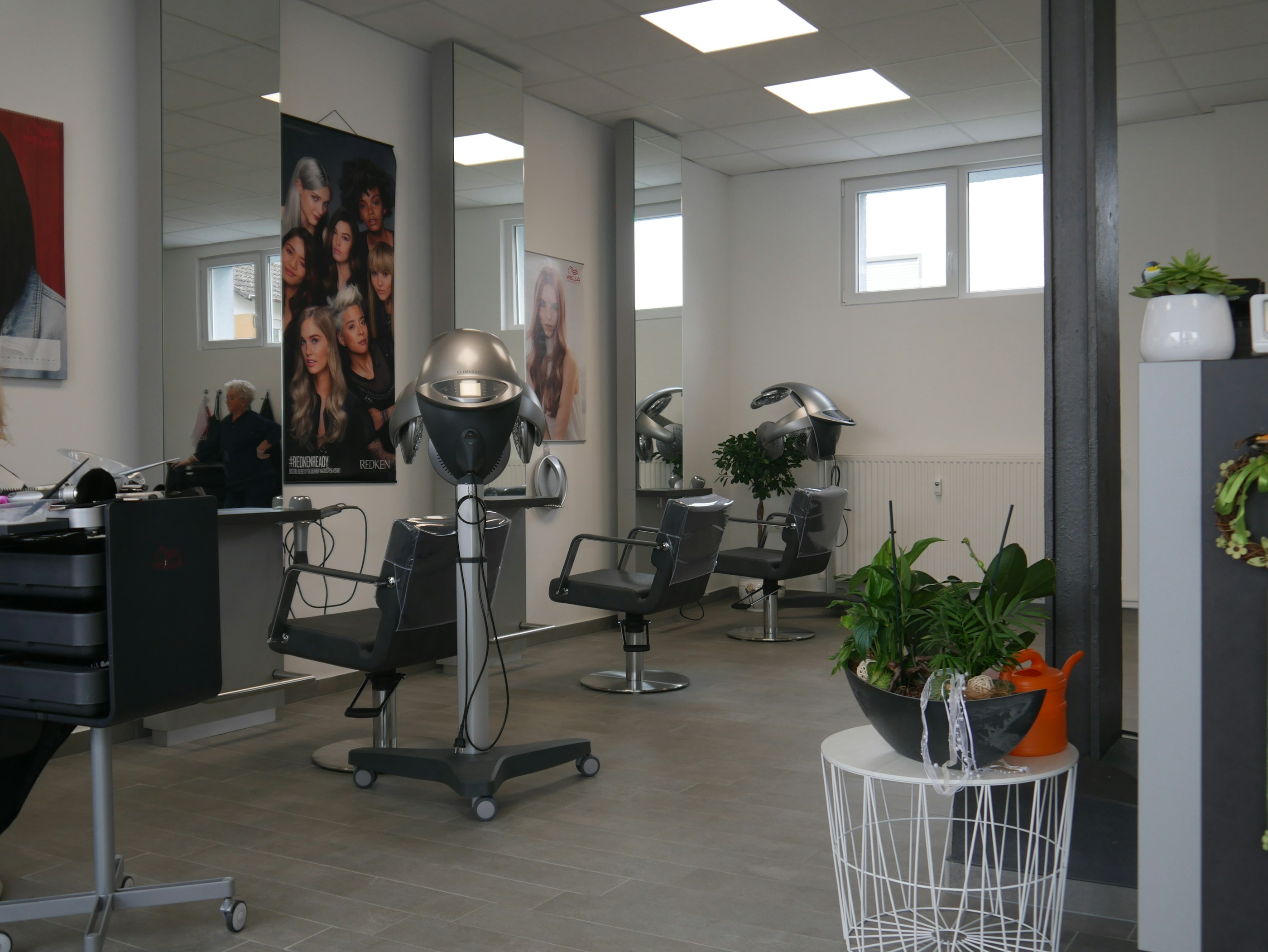 A stylish modern salon interior with elegant lighting and comfortable chairs.